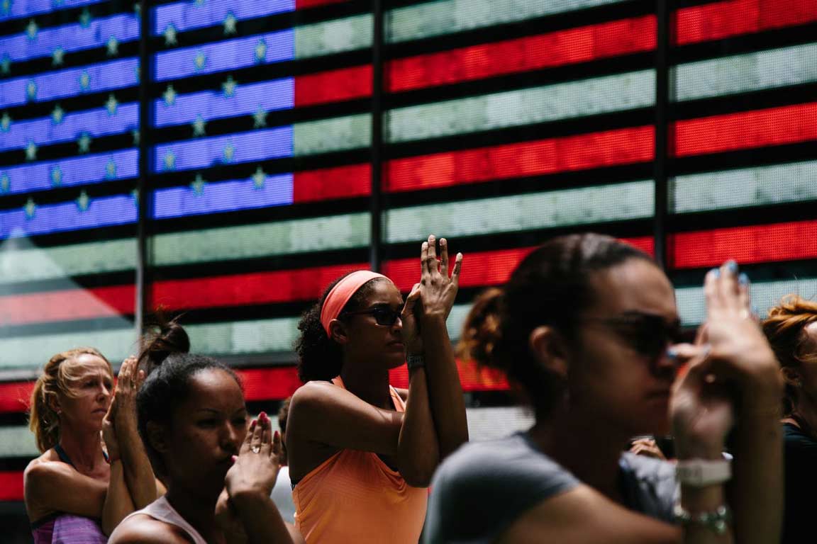 women marching with digital american flag in the background