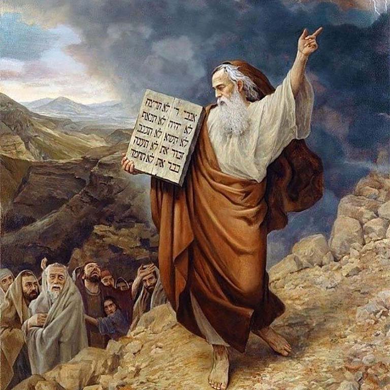 Man with white beard and stone tablet pointing to the sky